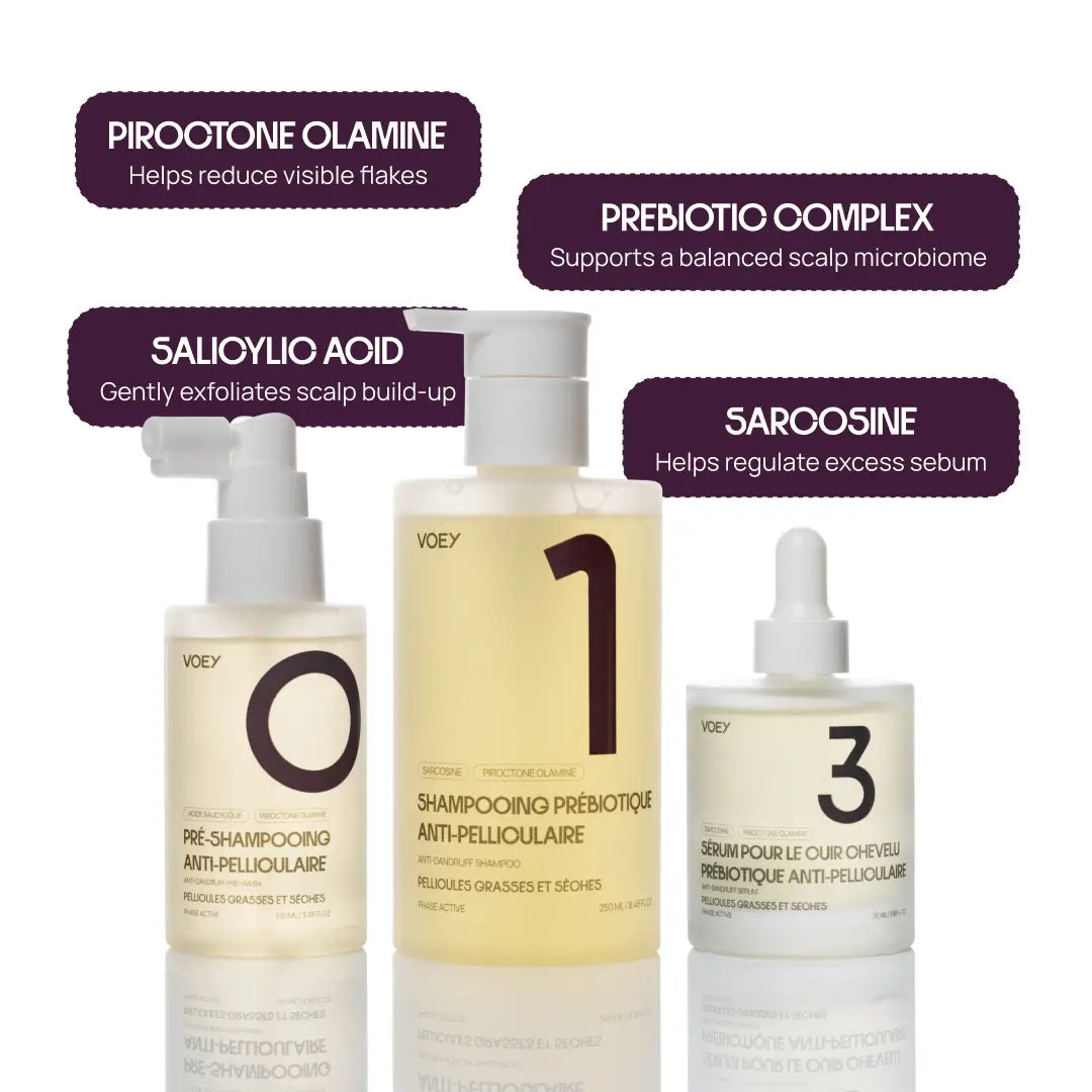 Three VOOY anti-dandruff shampoo bottles arranged on a white background with dark purple text callouts naming ingredients: Piroxtone Olamine, Prebiotic Complex, Salicyloyl Acid, and Sarcosine.